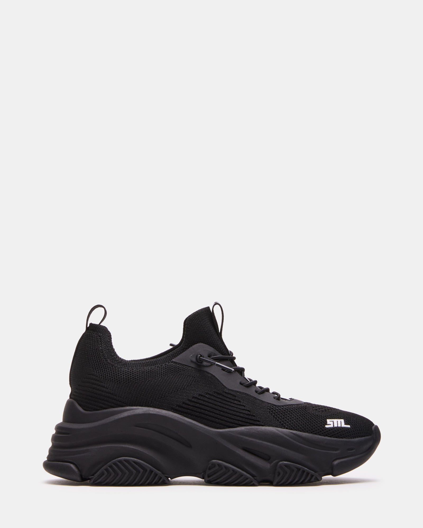 VAULT black sneakers side view on urban street