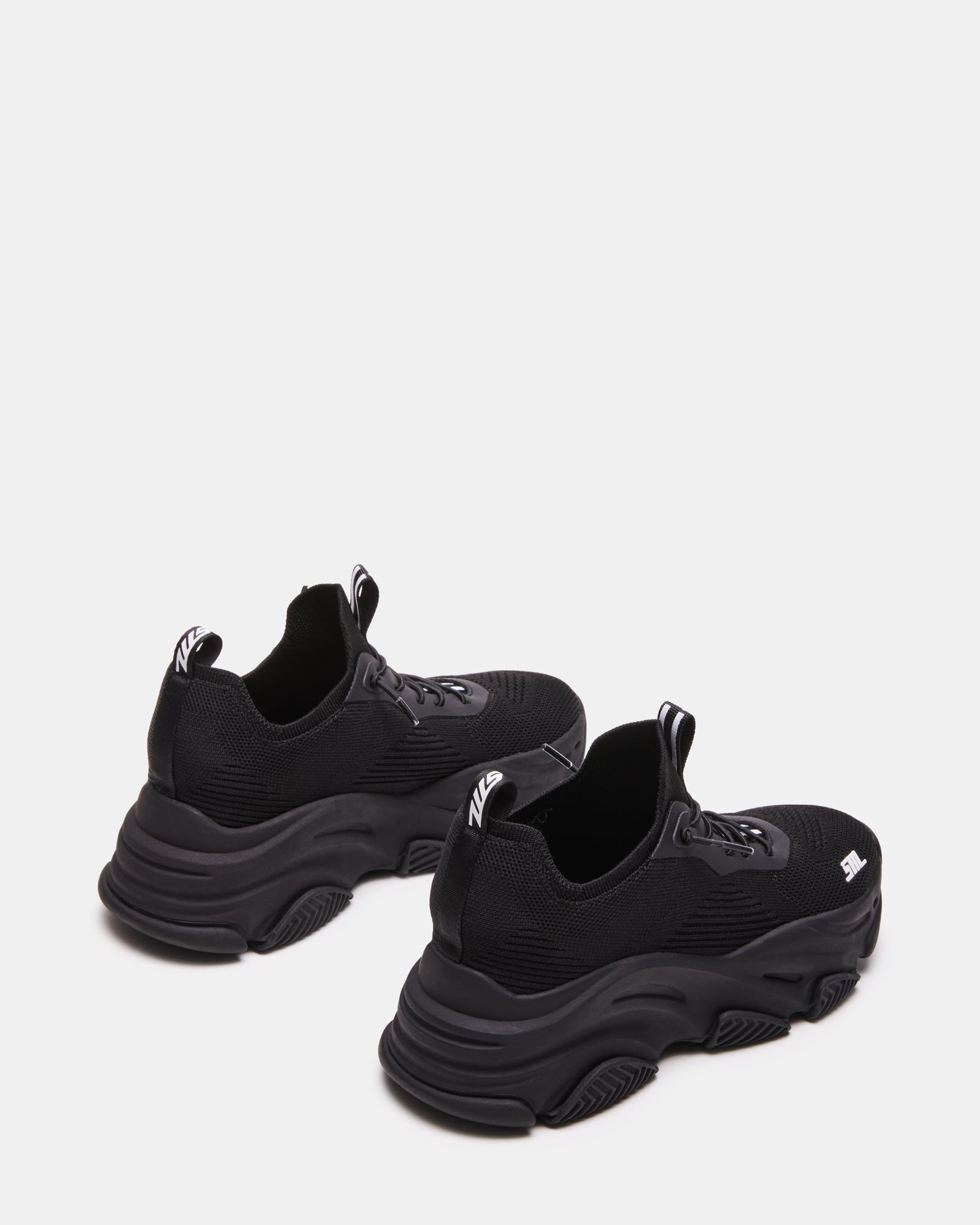 Person walking in VAULT sneakers highlighting sole flex