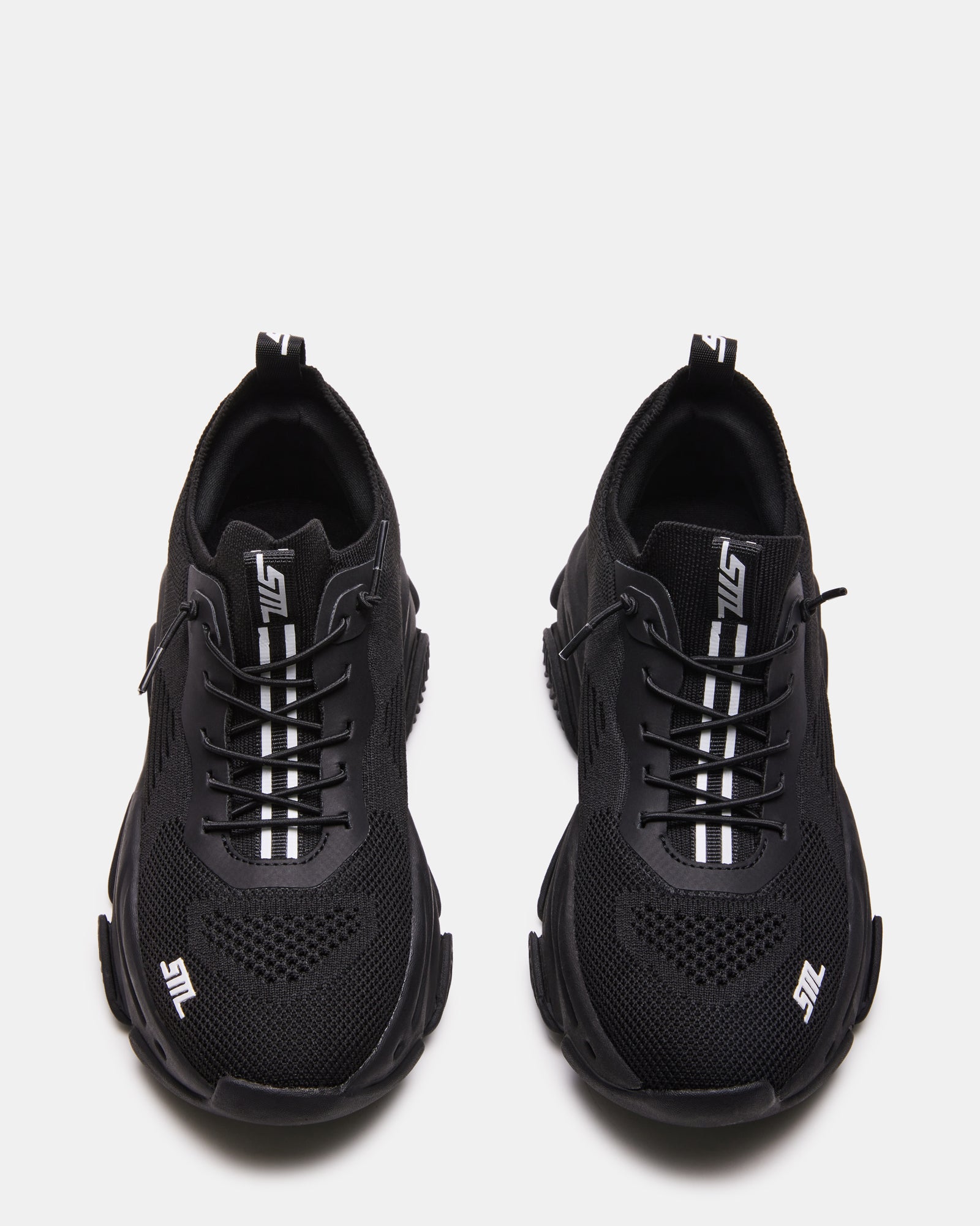 VAULT black sneakers side view on urban street