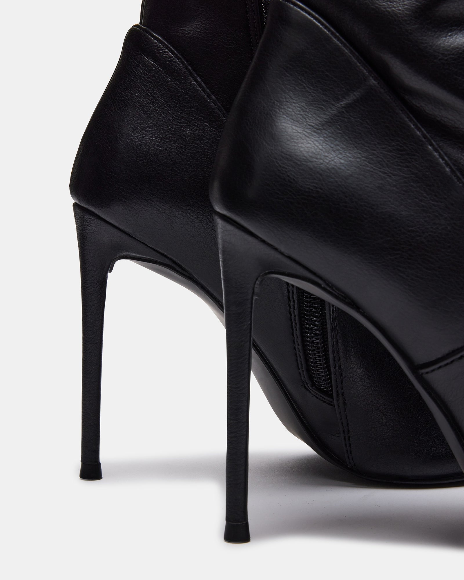 Side view of stiletto shoe boots showing full shaft height and pointed toe.
