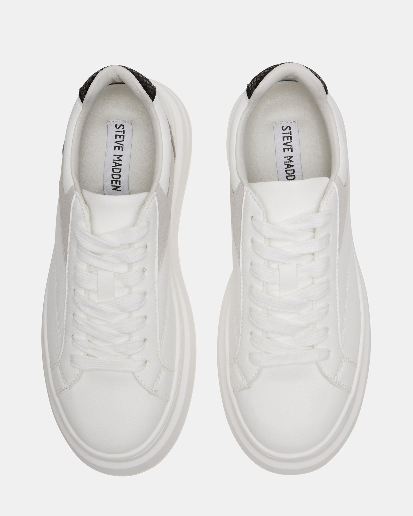 White vegan leather sneakers from a side angle, showcasing the platform sole