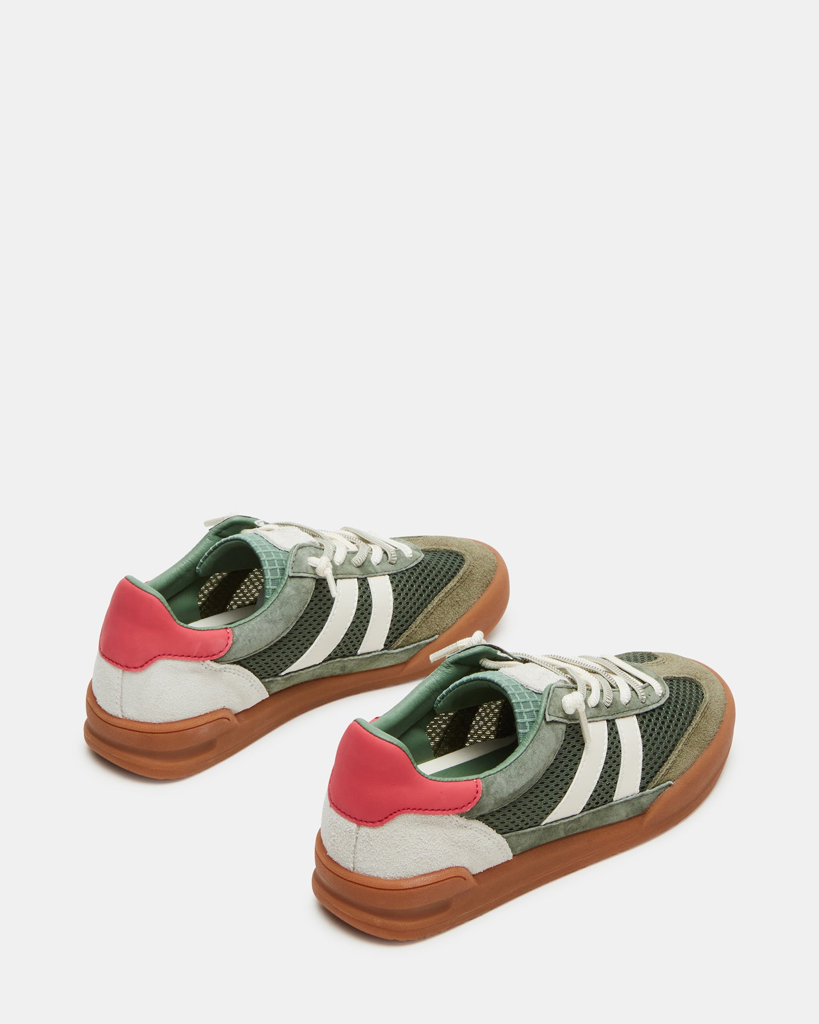 Model wearing Verdict Green low-top sneakers in a casual setting.