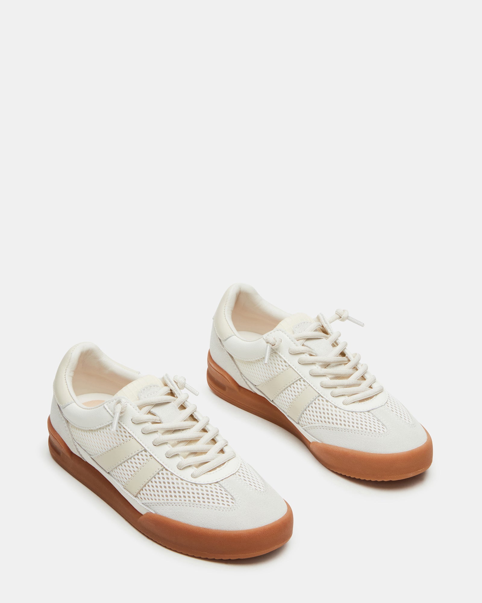 White sneakers styled with jeans and a casual outfit for everyday use