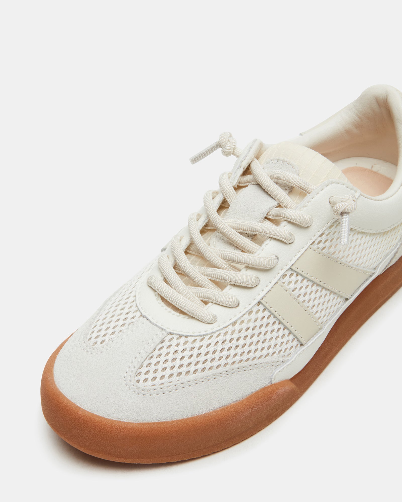 Side view of stylish white leather sneakers with platform heel for casual wear