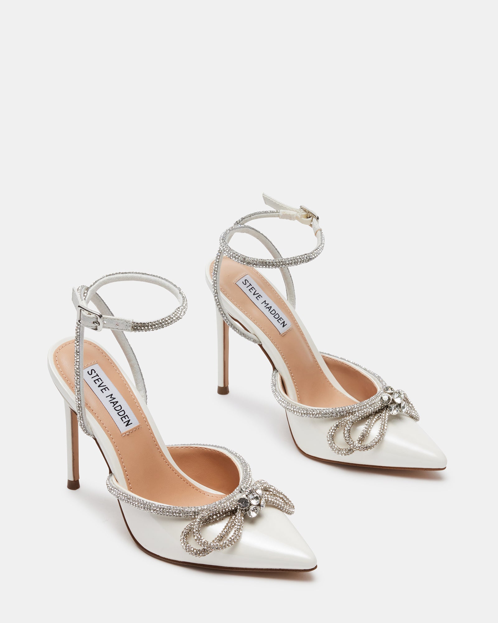 Close-up of off-white stiletto heels showcasing rhinestone details.