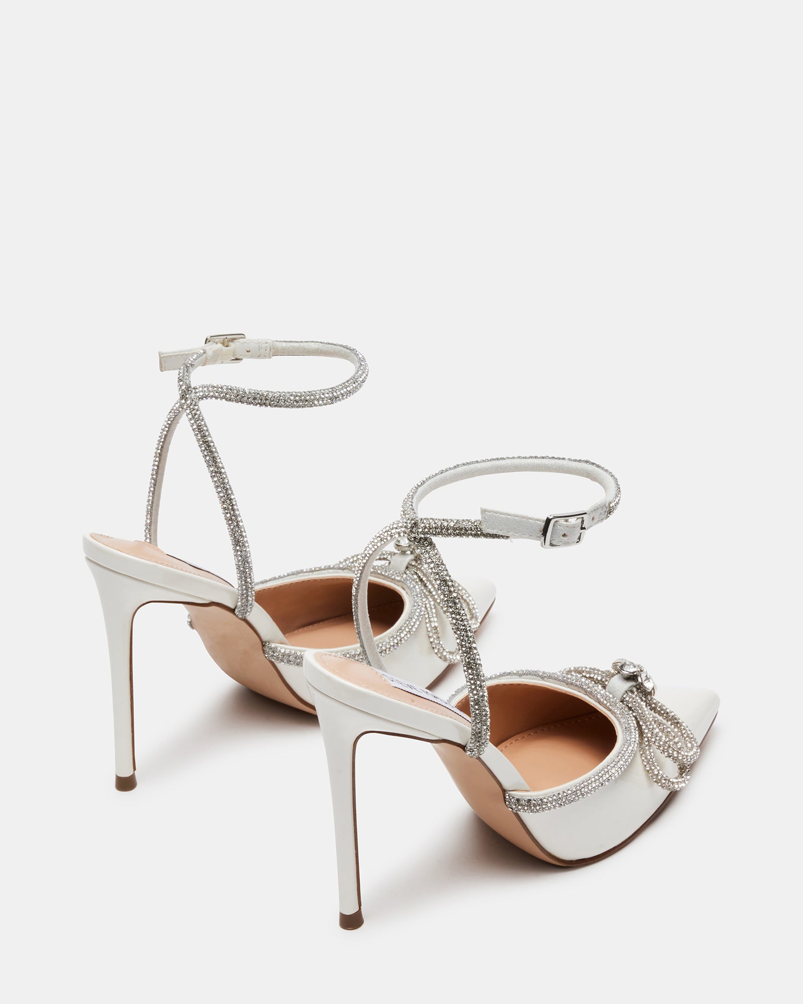 Close-up of off-white stiletto heels showcasing rhinestone details.