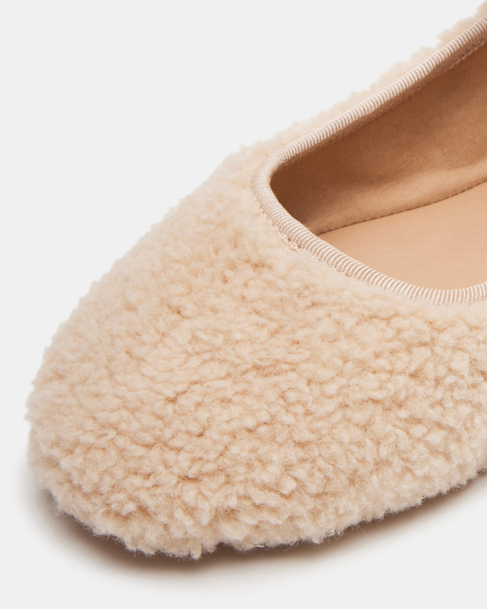 Side view of faux shearling Mary Jane shoes showing buckle detail