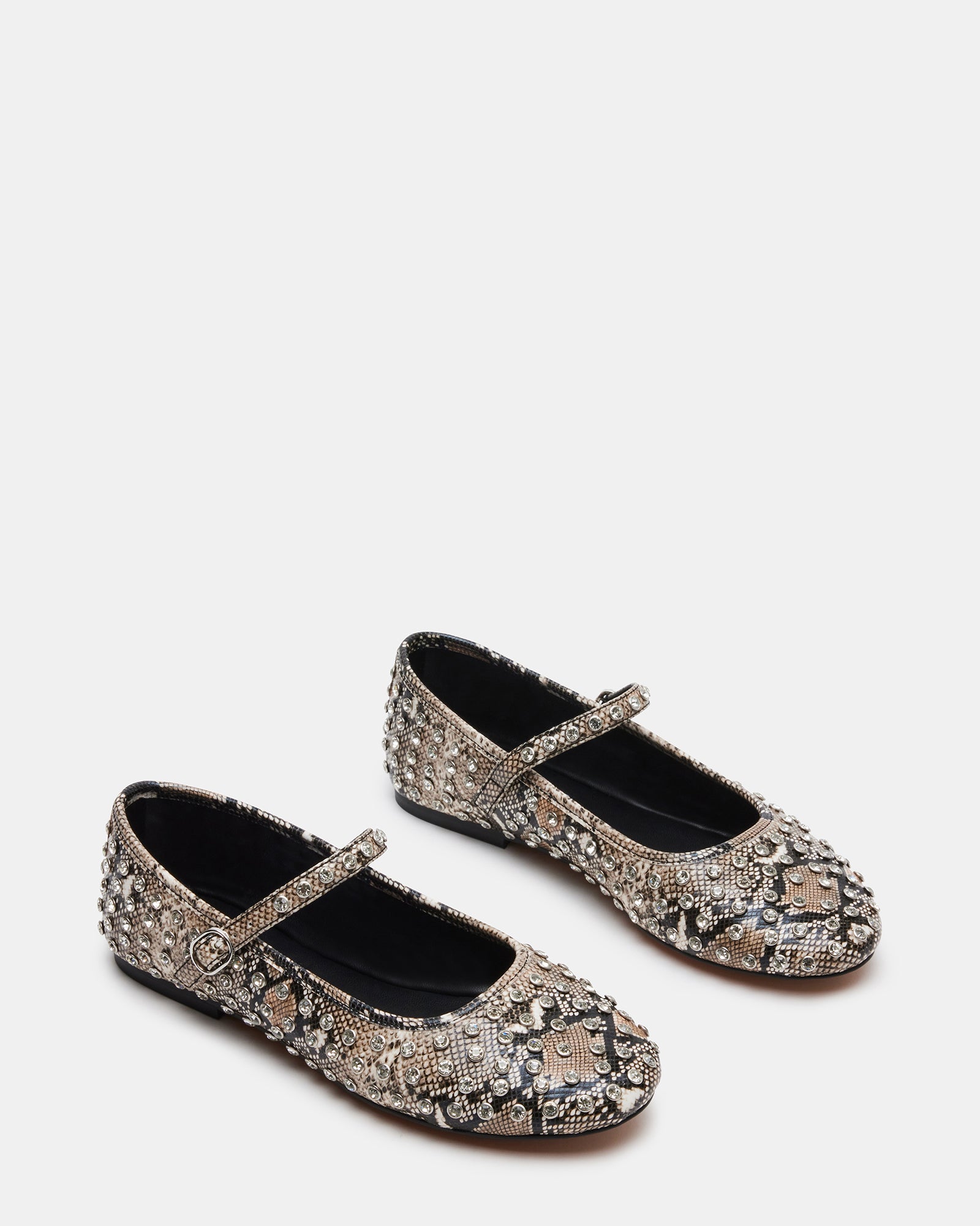 Model wearing rhinestone flats in urban setting