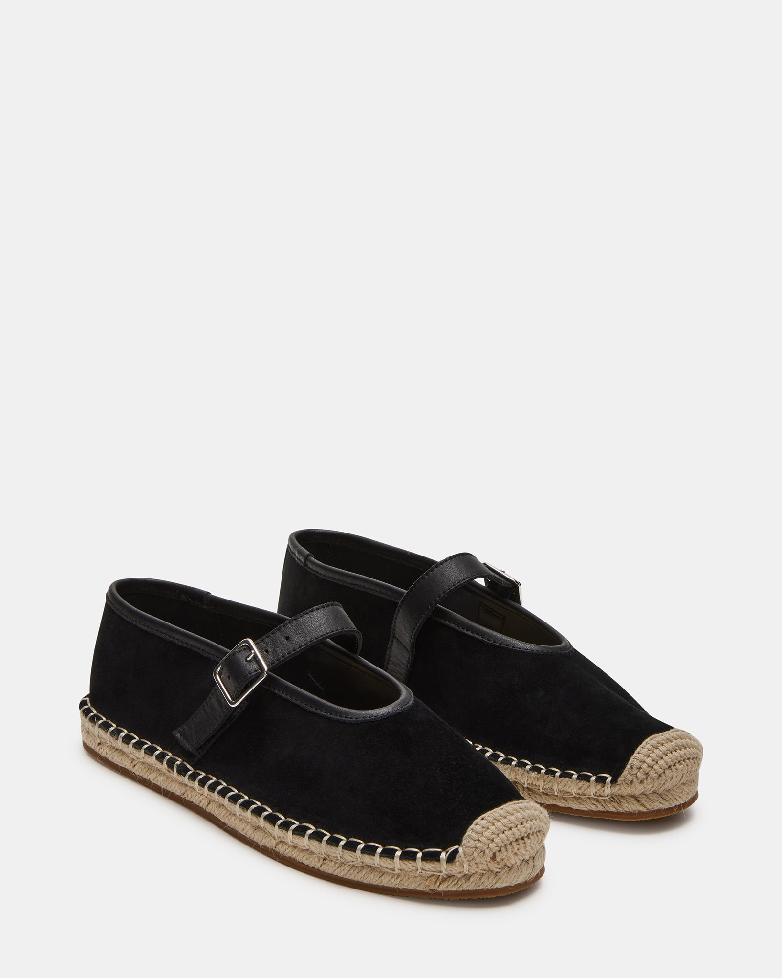 Close-up of the black suede flats, showing the soft texture and design.