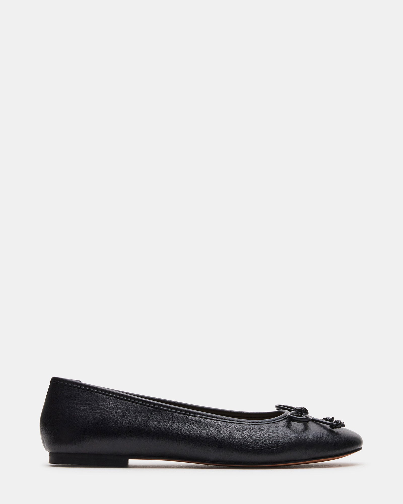 Black ballet flats styled with jeans for a casual look.