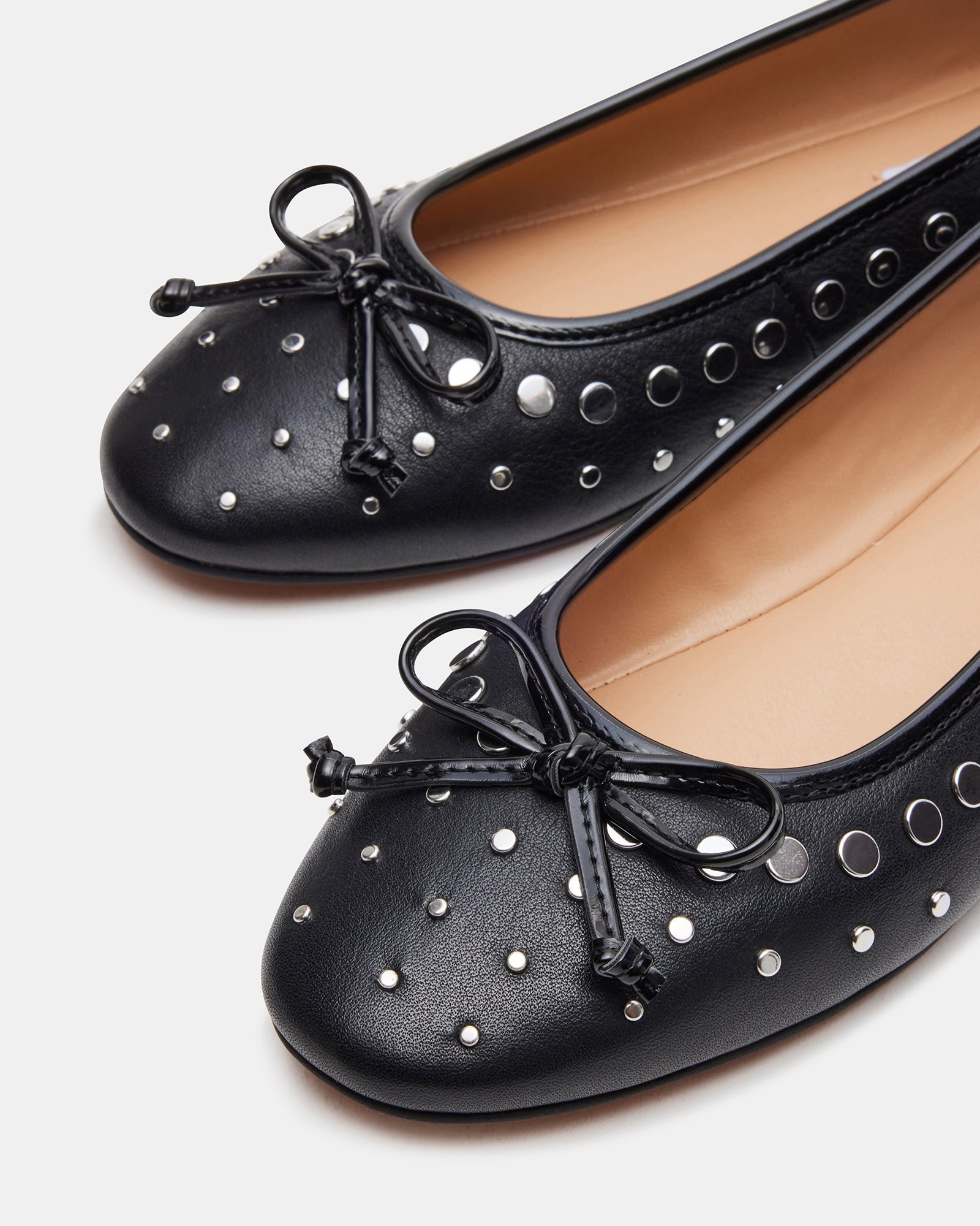 Close-up of the textured leather upper and synthetic sole of ballet flats