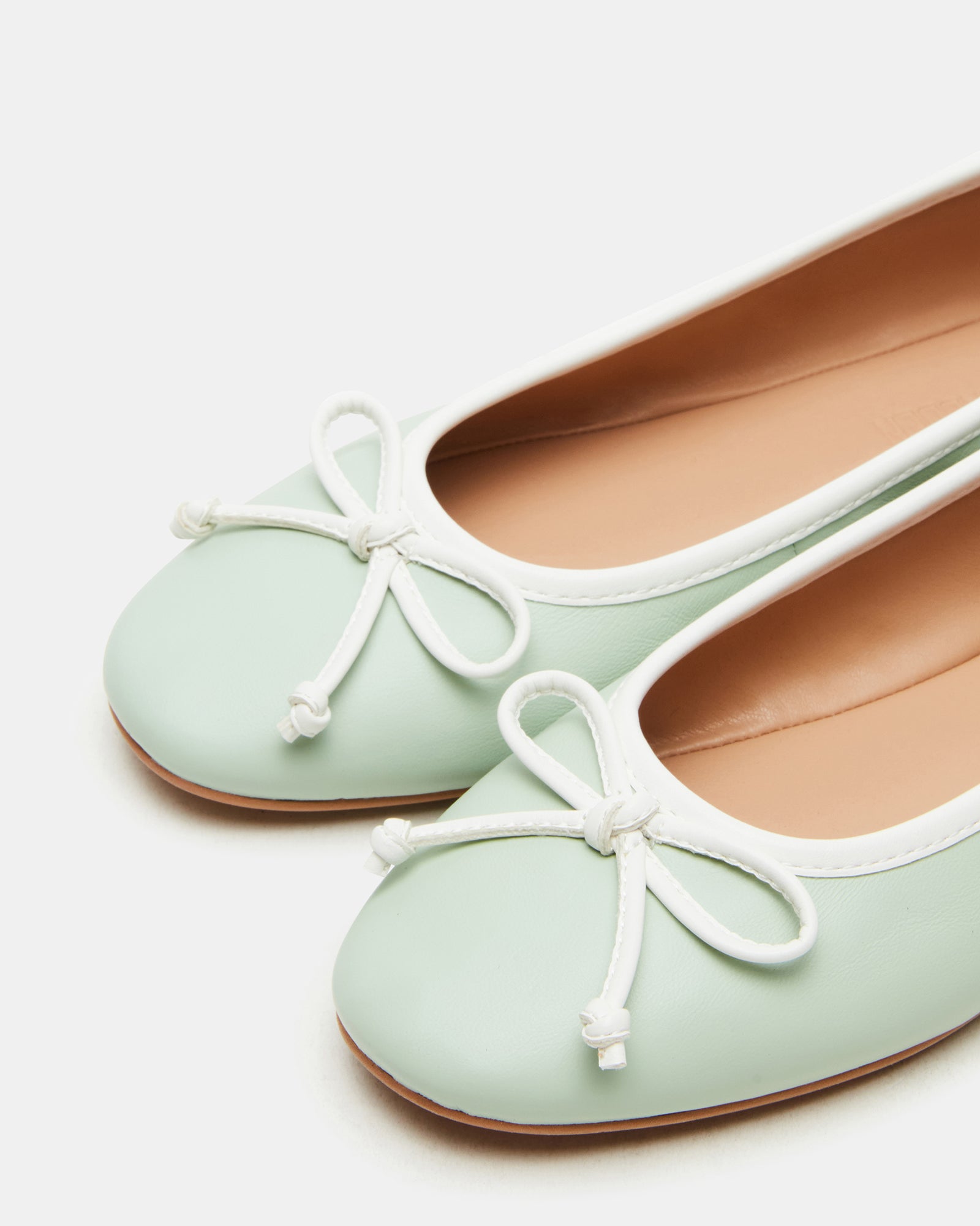 Close-up of mesh ballet flats highlighting lightweight synthetic material.