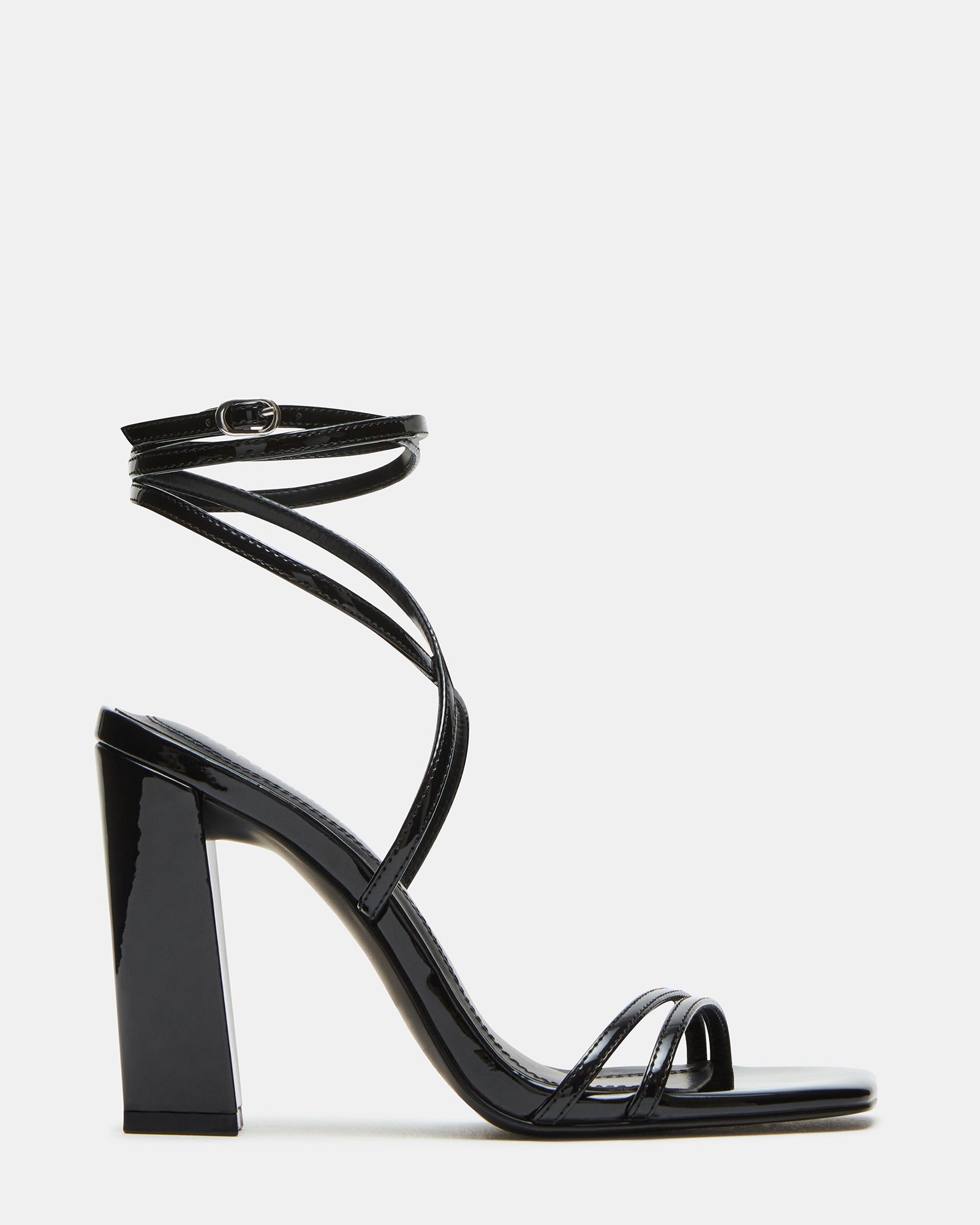 Black high heels on marble floor with handbag
