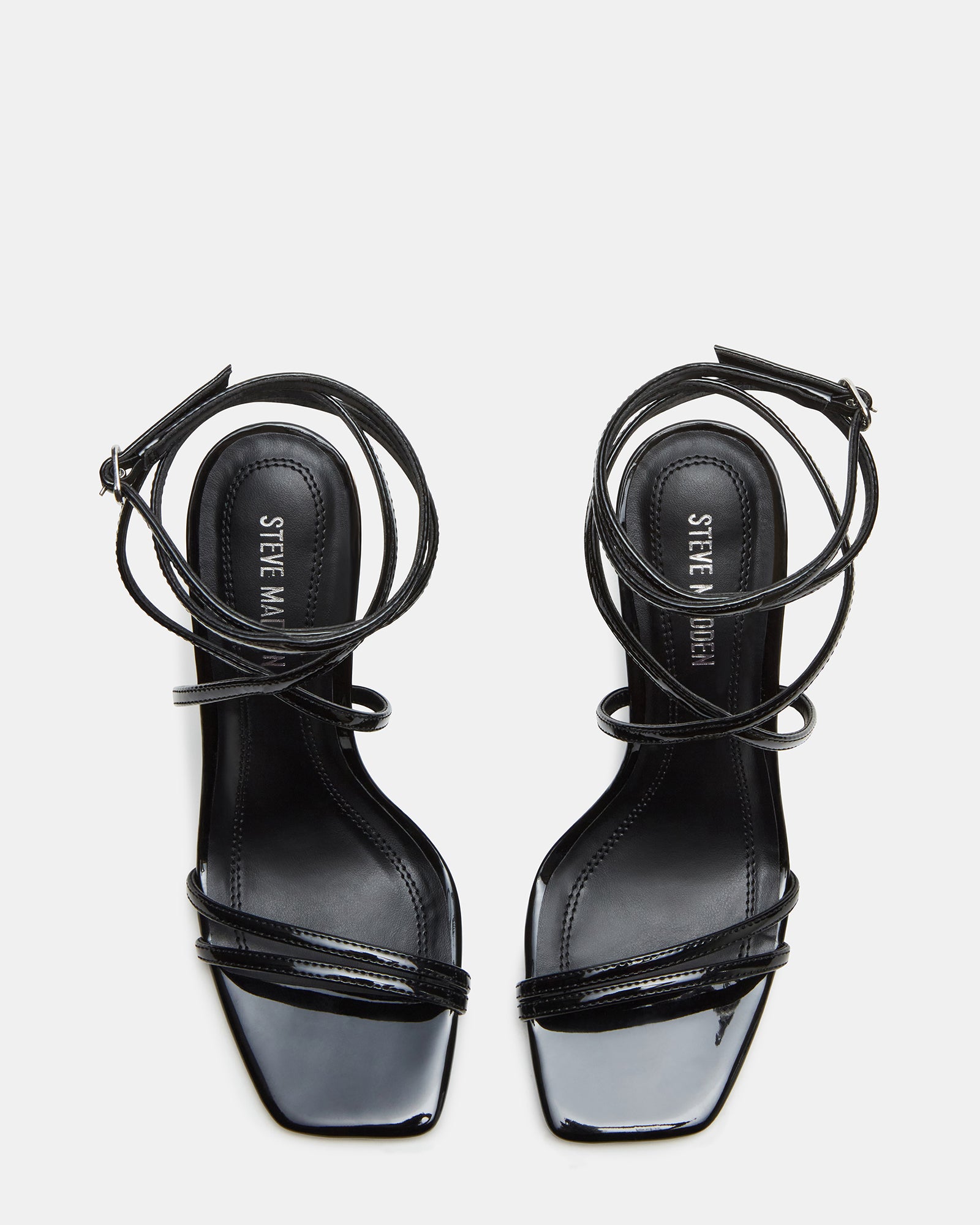 Black high heels on marble floor with handbag