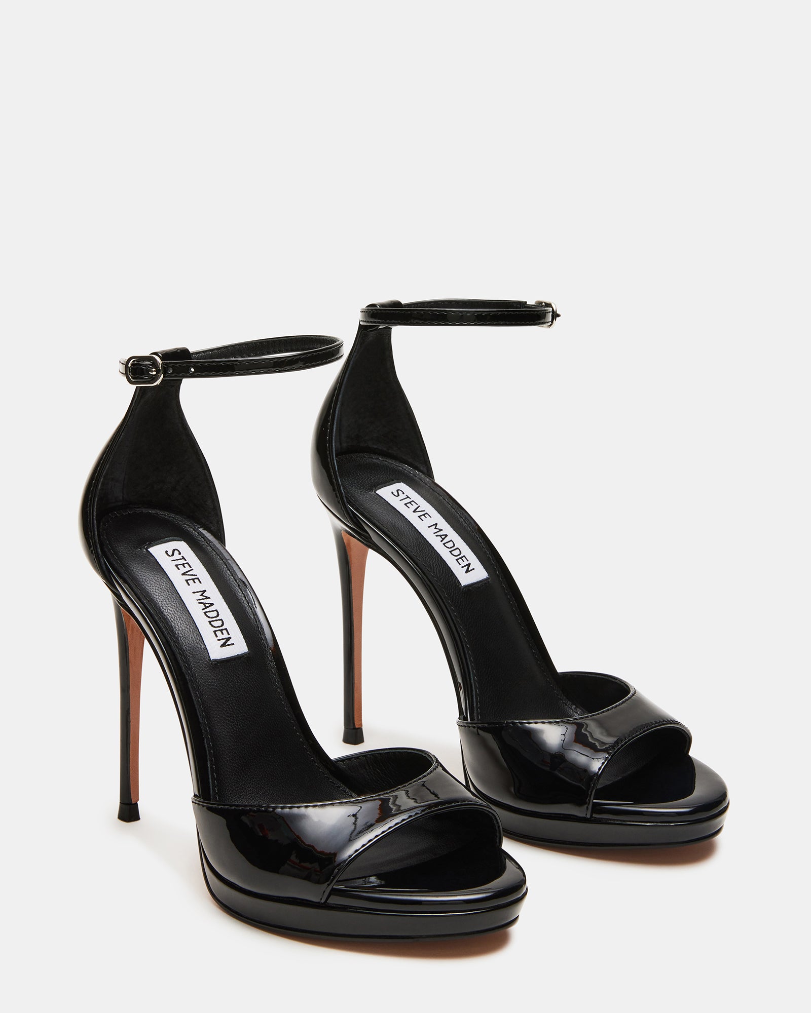 Woman wearing black strap around ankle heels at an event