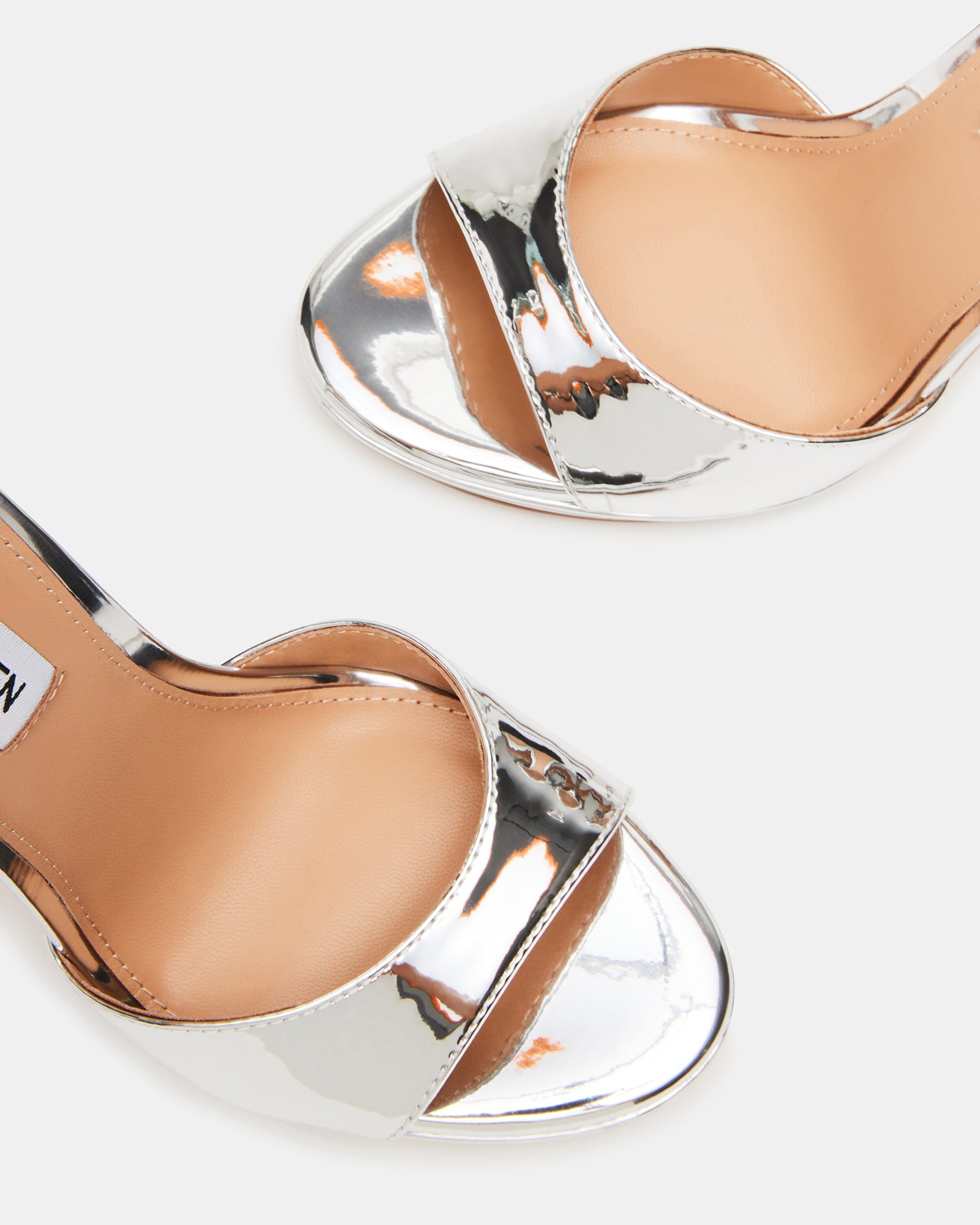 Close-up of the black strap around ankle heels, highlighting the leather lining.