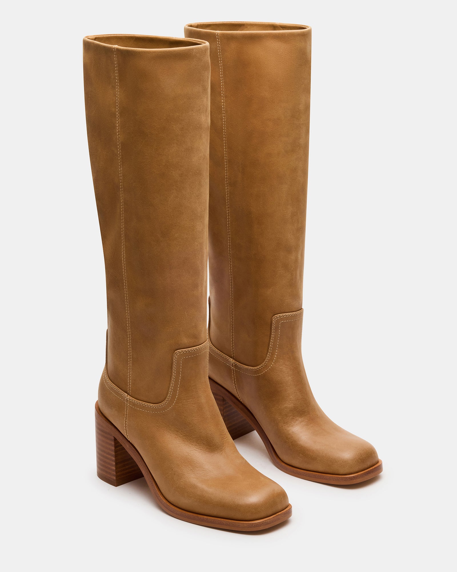 Fashionable knee-high boots with 3-inch heel on a city street