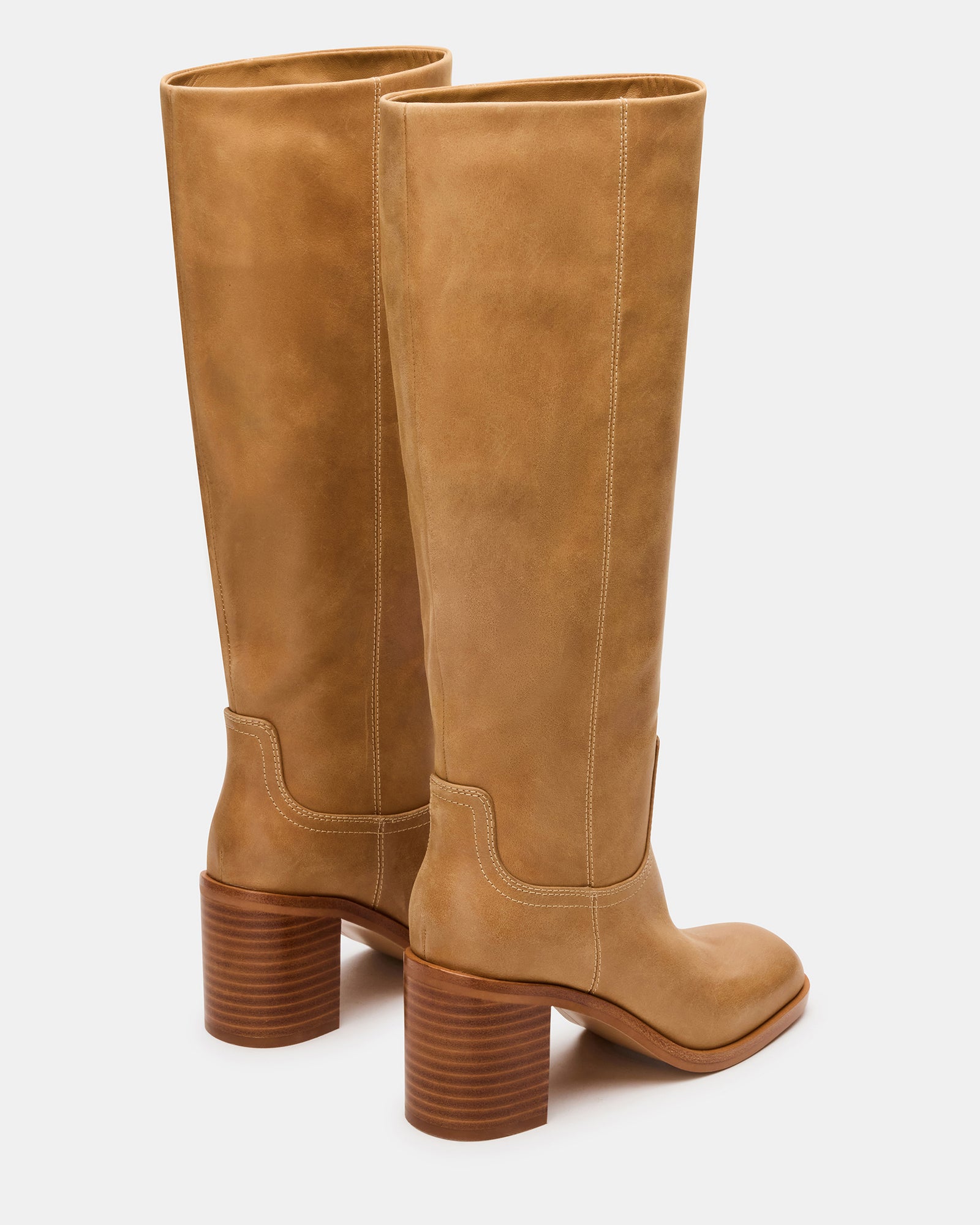 Fashionable knee-high boots with 3-inch heel on a city street