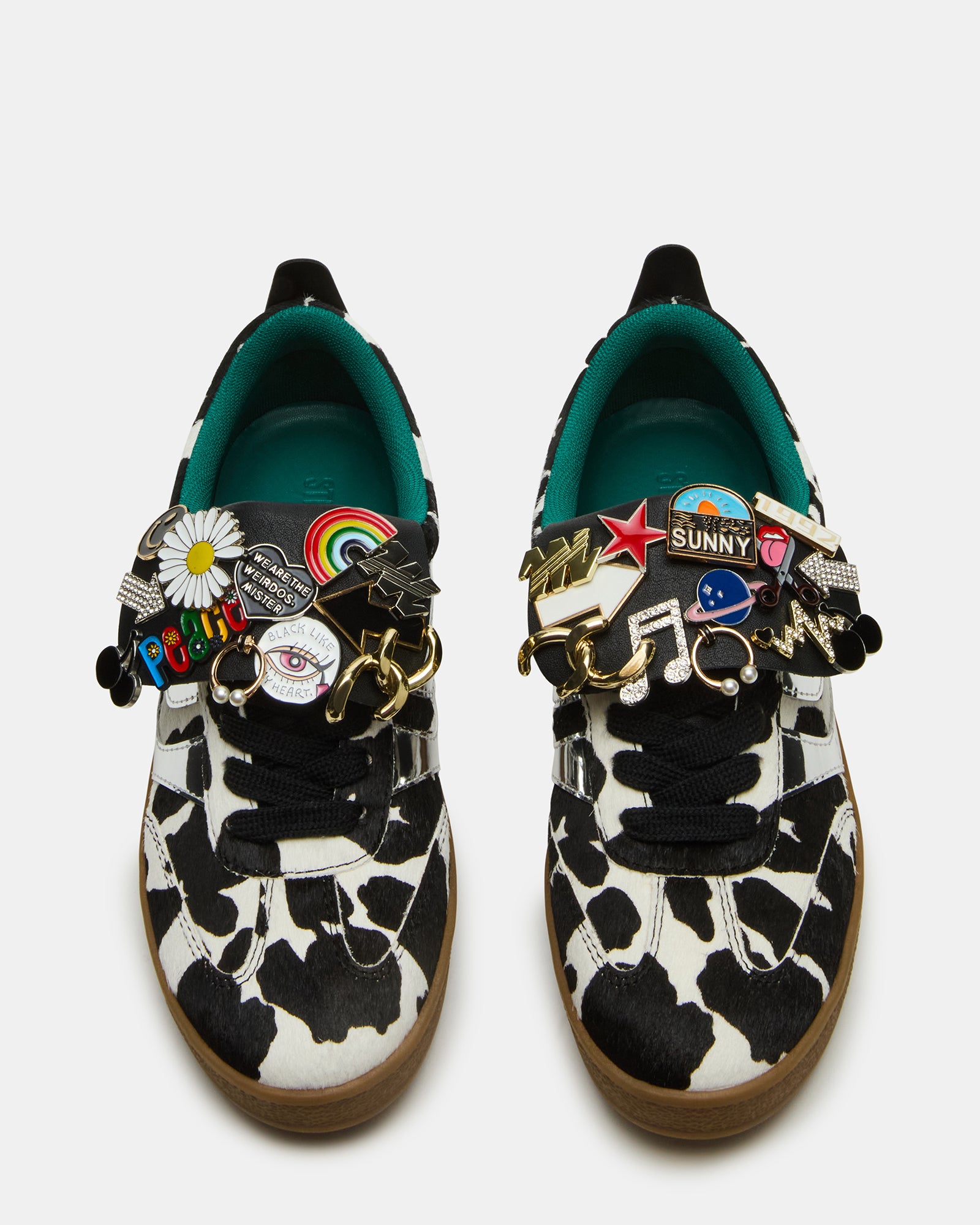 Front view of Custom Wyatt Black Cow Print Sneakers with colorful pins