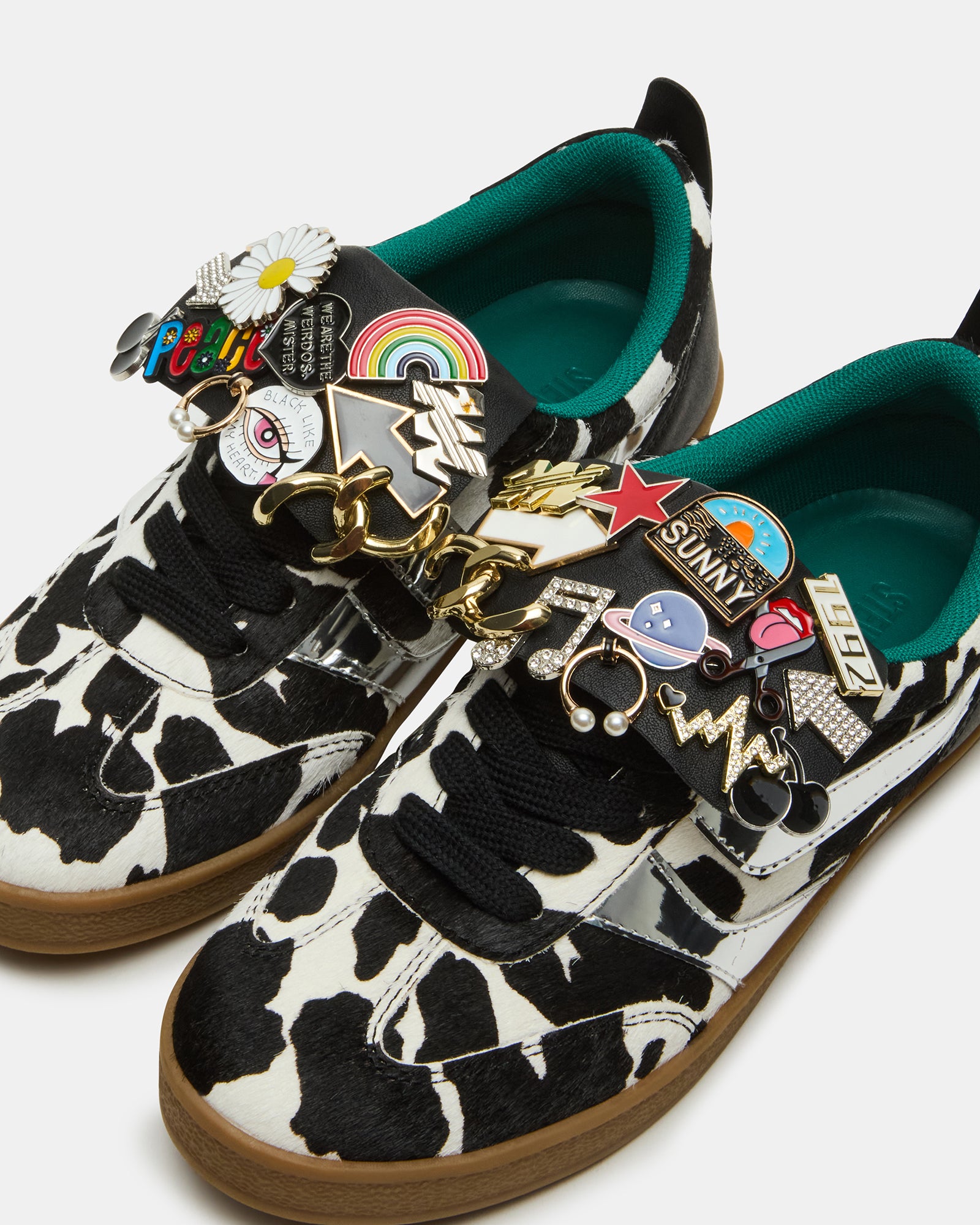 Detailed view of the synthetic sole of Wyatt Black Cow Print Sneakers