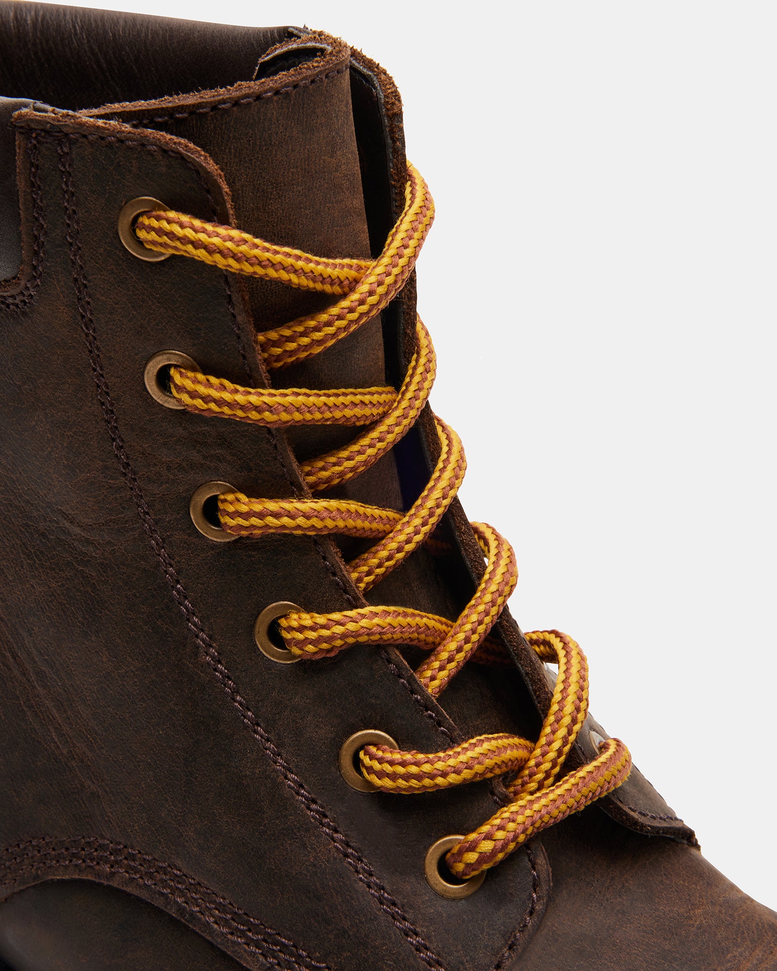 Close-up of brown leather knee high boots showing textured craftsmanship