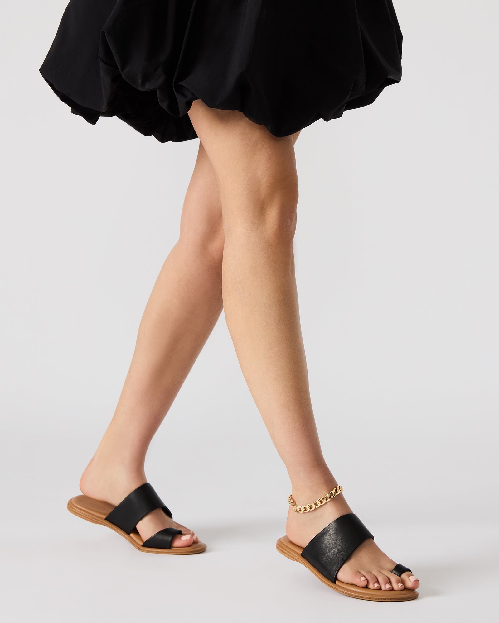 Close-up of the leather texture and craftsmanship on Zanis olive flat sandals