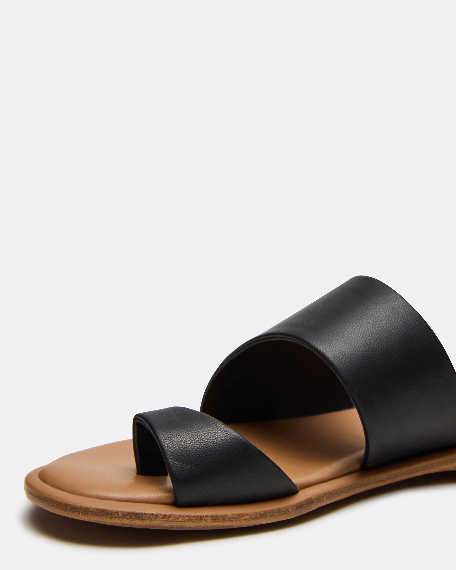 Flat slide sandals next to permanent jewelry anklets in packaging shot, ideal for gifting.