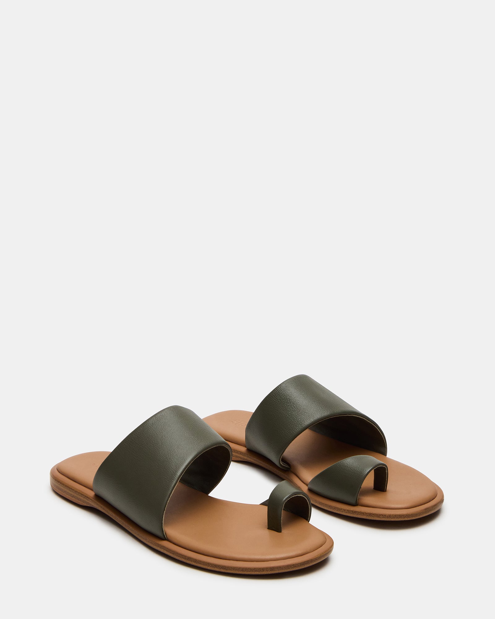Side profile showcasing the flat sole and sleek slide design of the Zani sandals