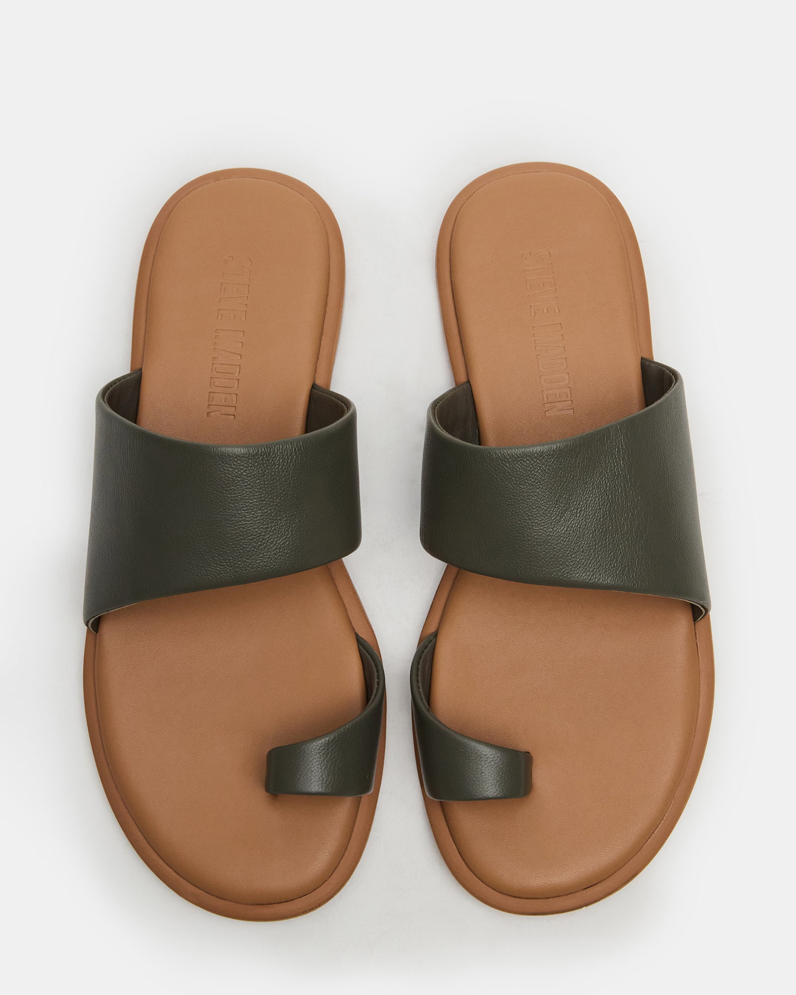 Top-down view of Zani olive leather slide sandals placed beside summer accessories