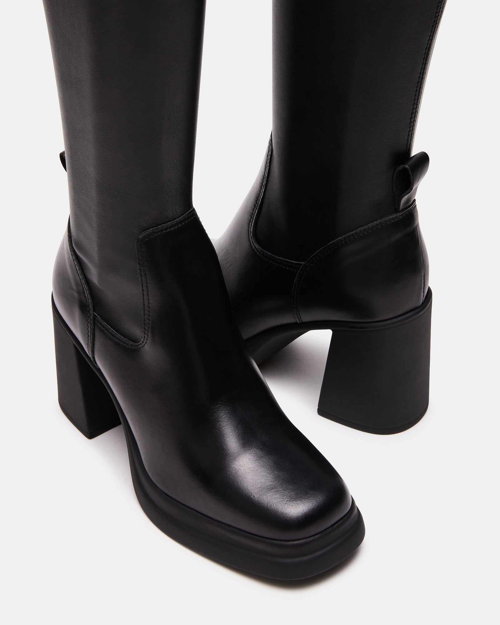 Zenovia black block heel boots styled with a midi dress for evening wear