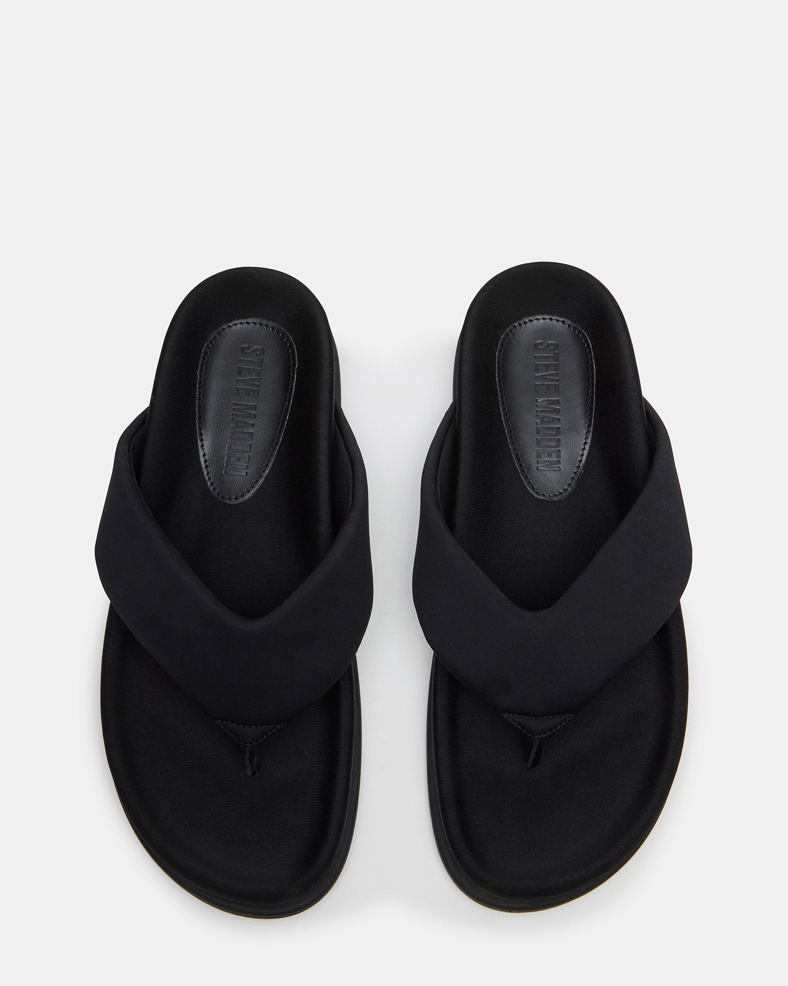 Side view of Zinnia black thong sandals showcasing the rounded toe design