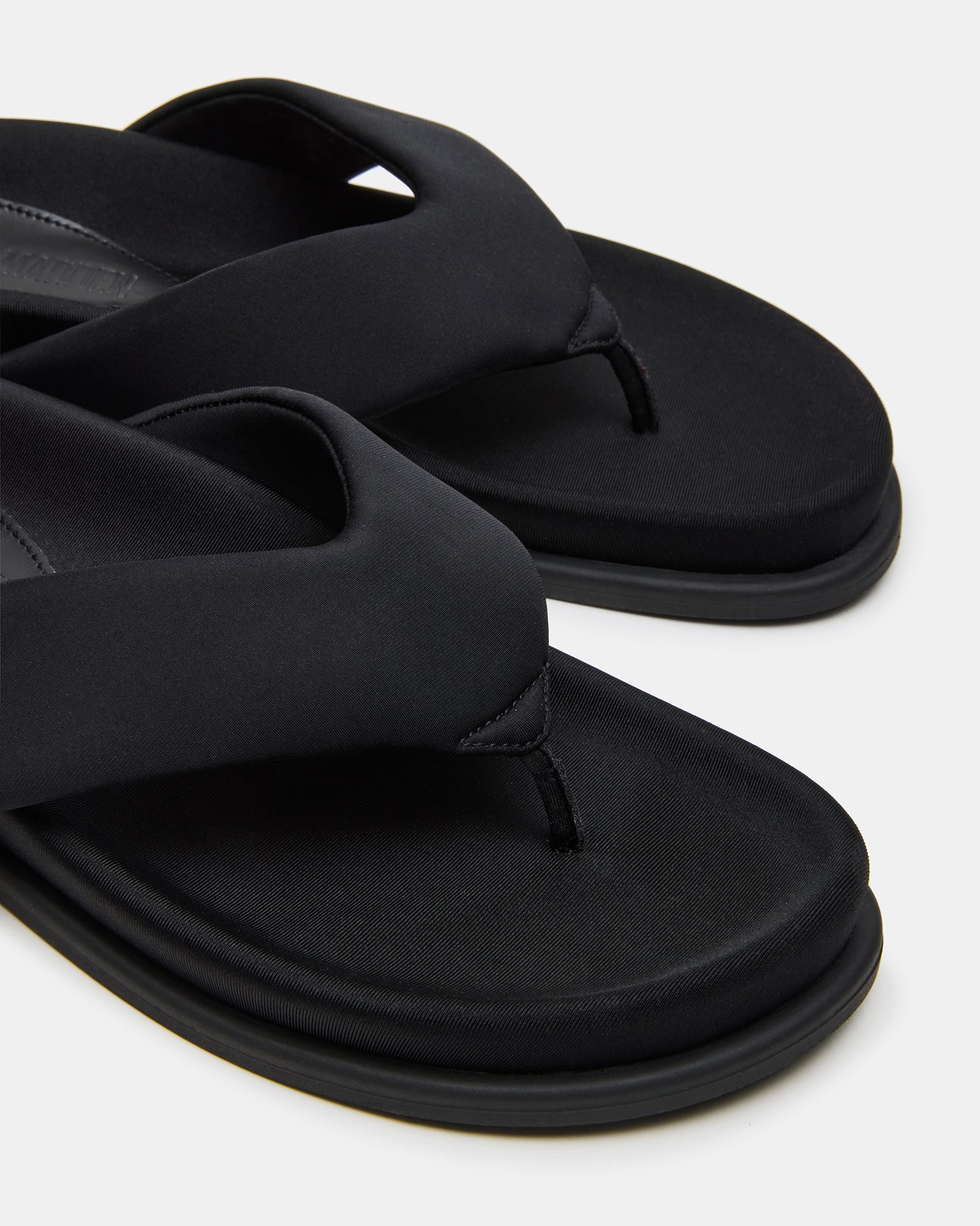 Close-up of Zinnia black sandals highlighting the soft footbed