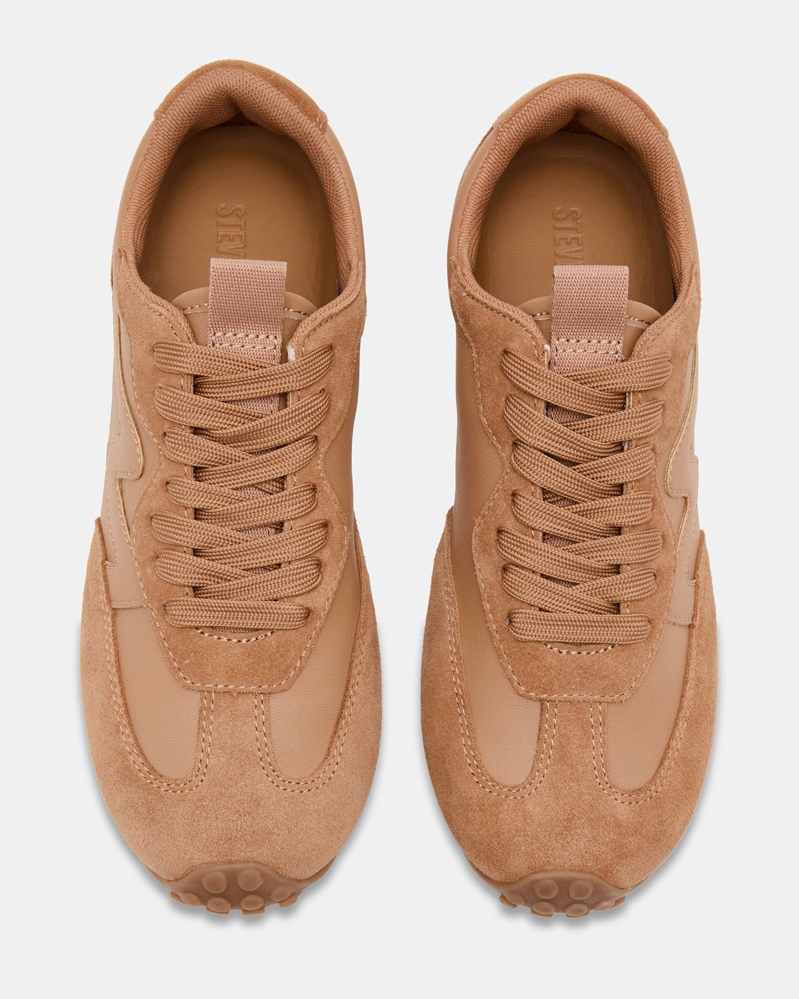 Side view of low-top sneakers with tan suede finish and lace-up design