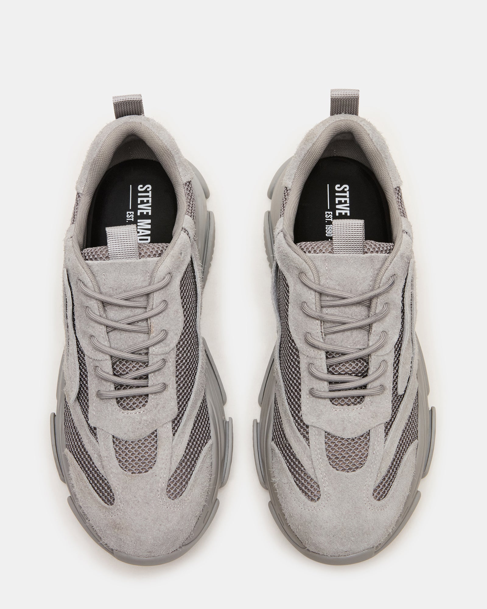 Close-up of the laced closure and mesh upper of the sneakers.