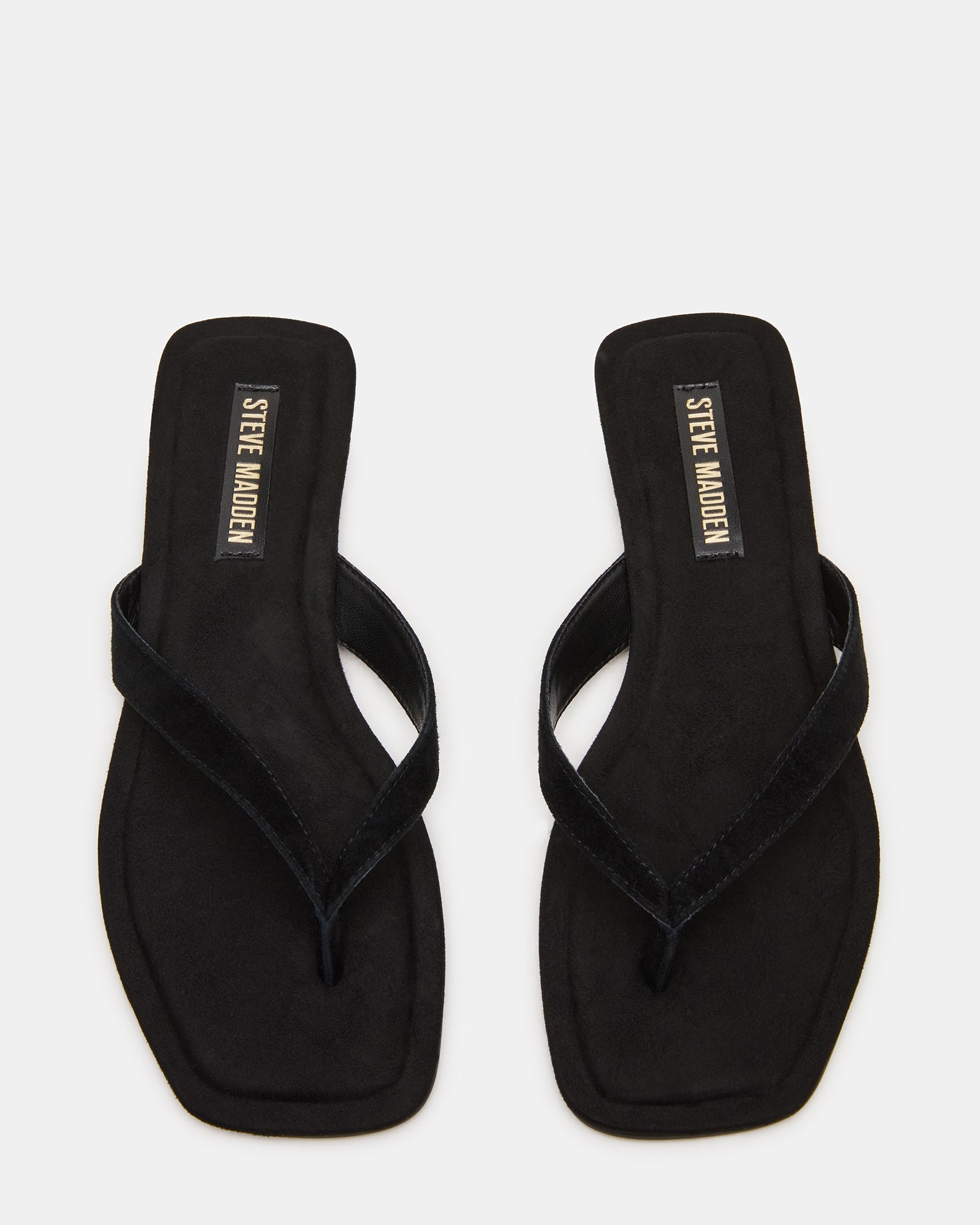 Side view of black suede sandals showing square toe and sleek strap