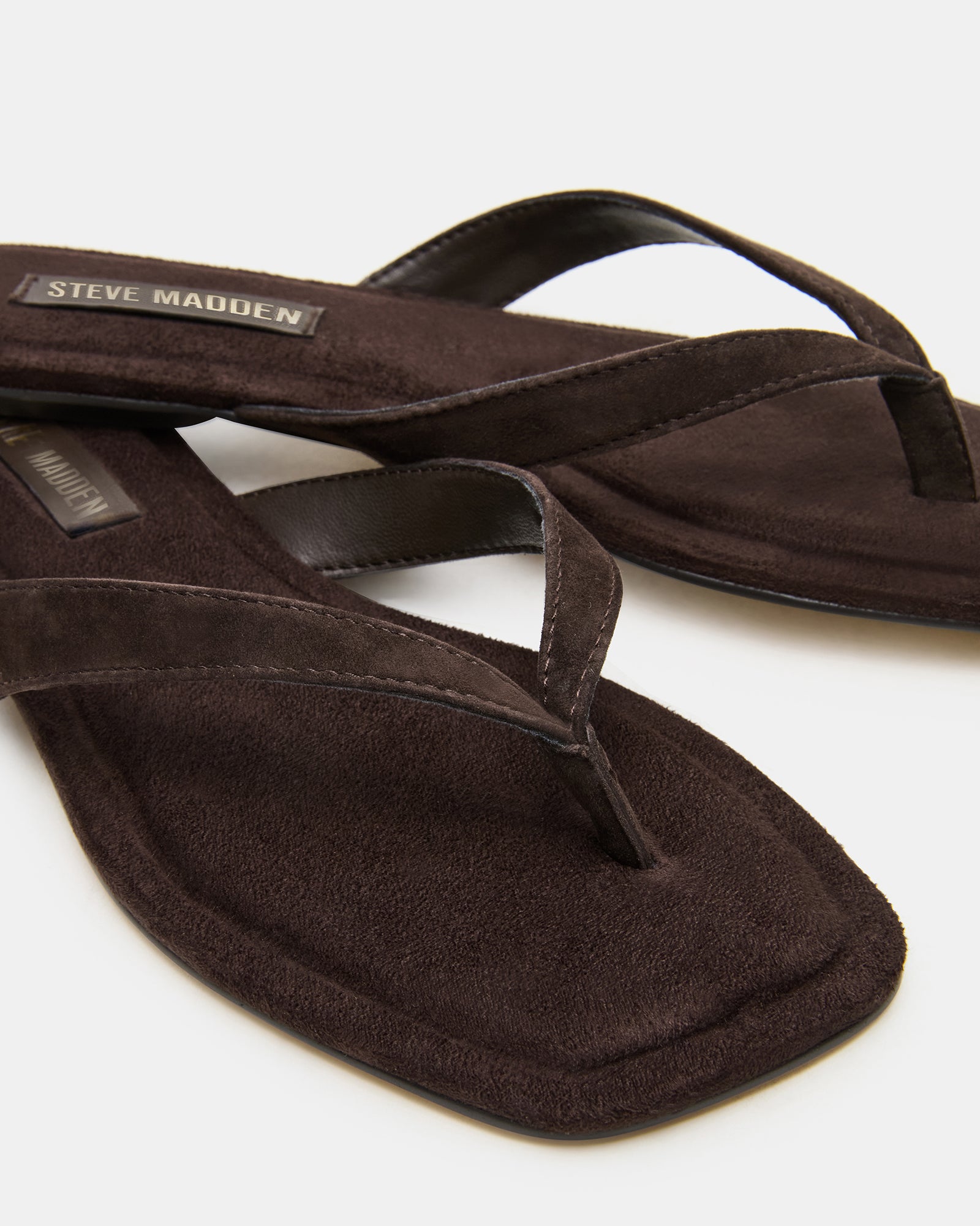 Lifestyle image with sandals worn on a sunny boardwalk in California