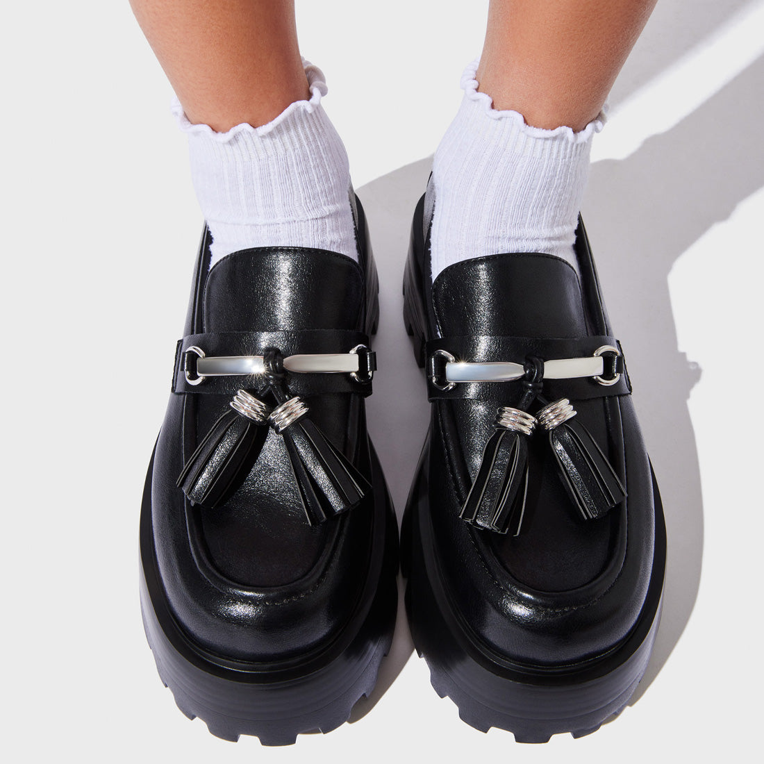 Model wearing the white low cut socks with sneakers for a casual studio-ready look